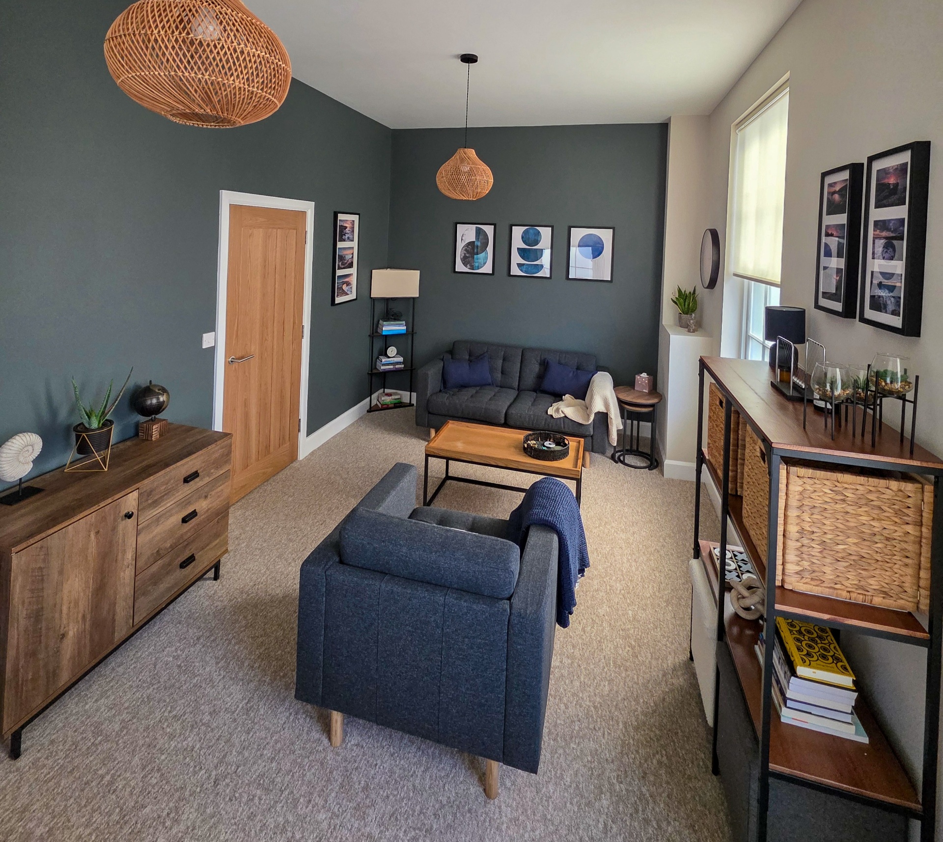 Interior of the consulting room, with muted green walls, natural light and warm wooden furniture